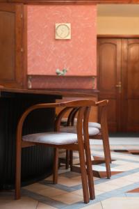 a chair and a table in a room at Pension Ibérica in Brno