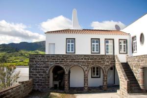 an external view of a house with a brick wall at Quinta Atlantis in Povoação