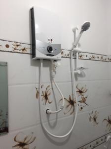 a shower in a bathroom with a hair dryer at Nhà nghỉ Sunrise in Quy Nhon