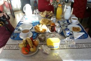 una mesa con platos de comida y tazas de café en La Kasbah Aalma D'or, en Najem