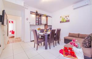 a kitchen and living room with a table and a couch at Apartment Marinero with FREE parking in Dubrovnik +28 photos