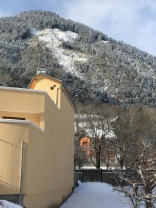 ein Haus vor einem schneebedeckten Berg in der Unterkunft Tout schuss in Saint-Étienne-de-Tinée