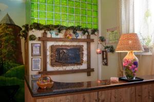 a room with a table with a lamp and green tiles at 12 Mesyacev in Nizhny Novgorod