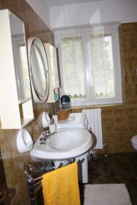 a bathroom with a sink and a mirror at Villa Anna in Sorico +34 photos