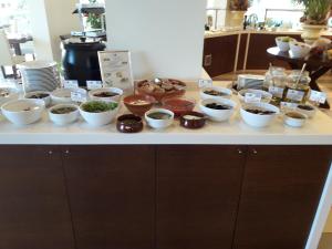 
a kitchen counter filled with bowls of food at Molos Bay Hotel in Kissamos
