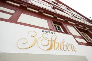 a sign on the side of a building at Boutique Hotel 3 Stuben in Meersburg