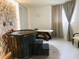 a bathroom with a wooden tub and a table at Hotel Terme Marine Leopoldo II TERME & SPA in Marina di Grosseto