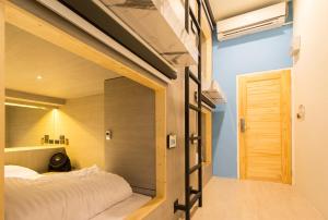 a small bedroom with a bed and a window at Lazy Sunday hostel in Bangkok