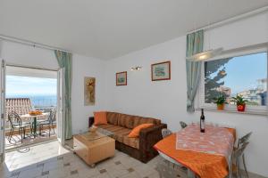 a living room with a couch and a table at Guest house Villa Ana in Baška Voda