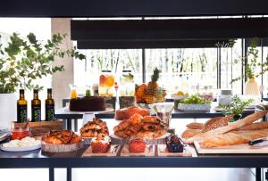 a buffet with bread and pastries and bottles of wine at Hotel Arima & Spa - Small Luxury Hotels in Donostia-San Sebastián