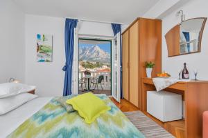 a bedroom with a bed and a view of a mountain at Guest house Villa Ana in Baška Voda