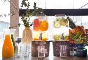 a group of glass jars filled with fruit and drinks at Hotel Arima & Spa - Small Luxury Hotels in Donostia-San Sebastián