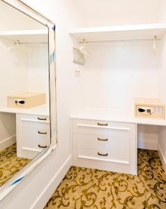 a dressing room with a mirror and a white vanity at The Olive Tree Hotel in Kyrenia