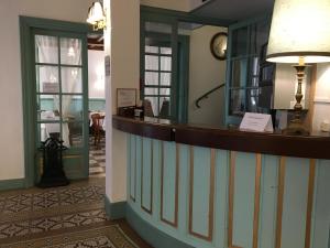 a lobby of a hotel with a reception counter at The Old Hotel Ravel Centre in Clermont-Ferrand