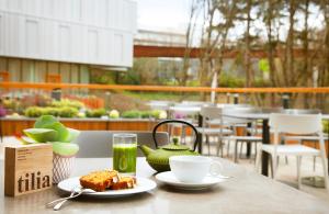 a table with a plate of food and a cup of coffee at Hotel Arima & Spa - Small Luxury Hotels in Donostia-San Sebastián