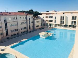 a large swimming pool on the roof of a building at Hotel Terme Marine Leopoldo II TERME & SPA in Marina di Grosseto