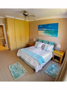 a bedroom with a large bed and two rugs at River Rooms - Chilled and Relaxed - Colchester - 5km from Elephant Park in Colchester