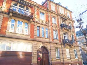 a large brick building with balconies on a street at Avenue de La Paix - L'Exclusif in Strasbourg