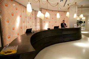 a man sitting at a desk with two laptops at Hotel Alfonso in Zaragoza