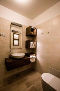 a bathroom with a sink and a mirror and a toilet at Apartment ALBA in Bovec