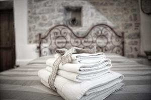 una pila de toallas sentadas encima de una cama en La Residenza Dei Cappuccini, en Spello