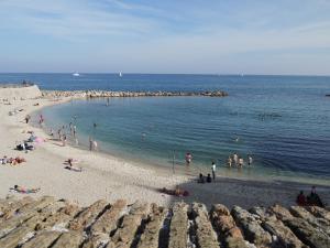 a group of people on a beach in the water at Vieille Ville 2 - La Petite Maison à Safranier, 2 bedrooms, max 4 adults and 2 kids in Antibes