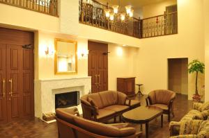 a living room with chairs and a fireplace at Kyu Karuizawa Hotel Otowa No Mori in Karuizawa