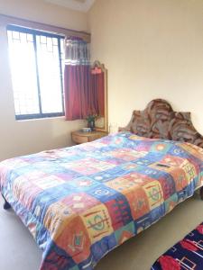 a bedroom with a bed with a colorful quilt on it at Cassi Studio with a view in Varca