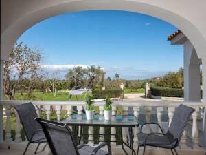 a patio with a table and chairs on a balcony at GK Holiday Home in Tragaki