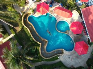 an overhead view of a swimming pool with red umbrellas at Top Resort in Ko Chang