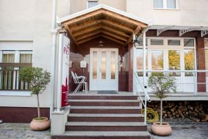 a house with a white front door and stairs at Hotel Pervan in Međugorje