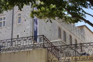 a flag on the side of a building with a staircase at Vieille Ville 2 - La Petite Maison à Safranier, 2 bedrooms, max 4 adults and 2 kids in Antibes