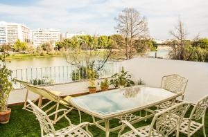 a patio with a table and chairs on a balcony at AlohaMundi Castilla I in Seville