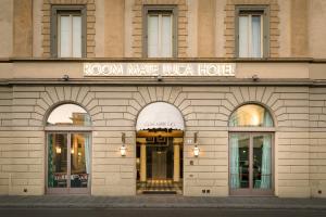 a building with a large window and a clock on the front of it at Room Mate Luca in Florence