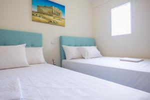Posteľ alebo postele v izbe v ubytovaní Acropolis View Paradise Apartments
