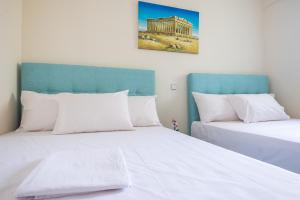 Posteľ alebo postele v izbe v ubytovaní Acropolis View Paradise Apartments