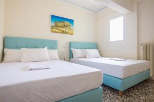 A bed or beds in a room at Acropolis View Paradise Apartments