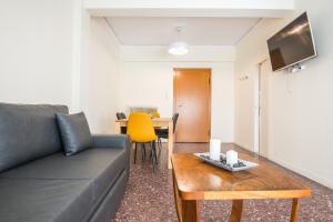 a living room with a couch and a table at Acropolis View Paradise Apartments in Athens