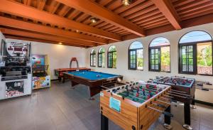 a room with two pool tables in a room with windows at 八村 Resort in Xiaoliuqiu