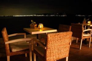 a table and chairs with a view of the water at Kekrifalia Hotel in Skala