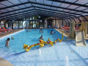 a group of people swimming in a swimming pool at Camping Le Ragis in Challans