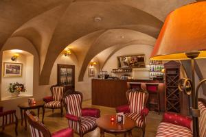 a bar with chairs and a table and a counter at Hotel Santi in Krakow