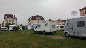 a group of recreational vehicles parked in a field at Zora Camping - Bungalows in Obzor