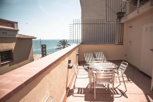 a balcony with a table and chairs and the ocean at Barcelona Beach Apartments in Barcelona