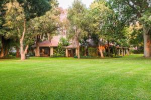 a house with a lawn in front of it at Sondela Nature Reserve & Spa Country House in Bela-Bela