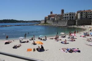 a group of people laying on a beach at Vieille Ville 2 - La Petite Maison à Safranier, 2 bedrooms, max 4 adults and 2 kids in Antibes