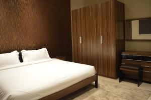 a bedroom with a bed and a cabinet and a television at Rafa Homes Al Izdihar 1 in Riyadh