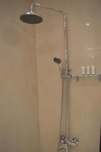 a shower with a shower head in a bathroom at Rafa Homes Al Izdihar 1 in Riyadh