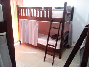 a small room with a bed and a window at Jomtien Hostel in Jomtien Beach
