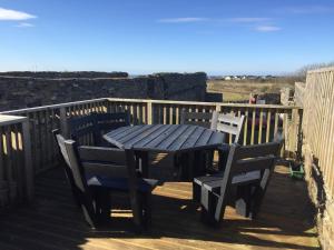 a wooden table and chairs on a deck at The Townhouse in Miltown Malbay